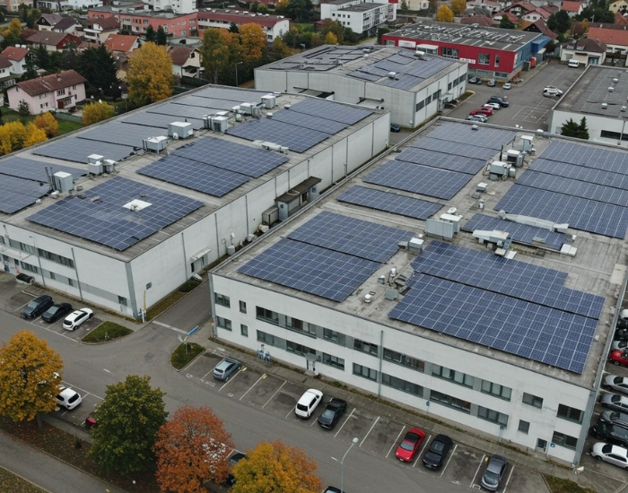 Aerial view of a commercial building with solar panels installed on the roof